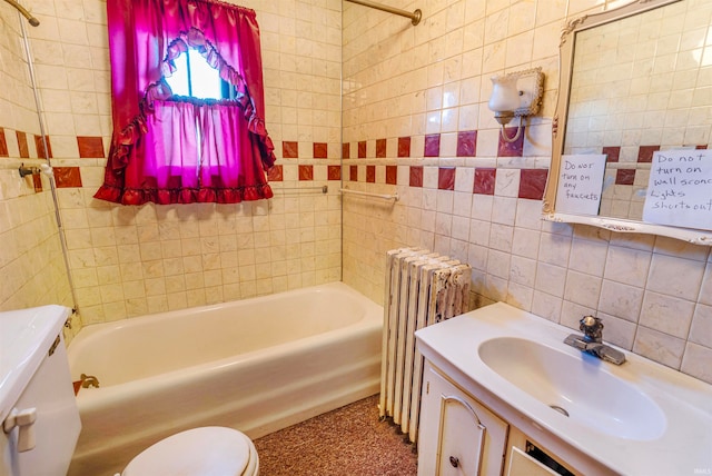 full bathroom featuring radiator, vanity, shower / bath combination, toilet, and tile walls