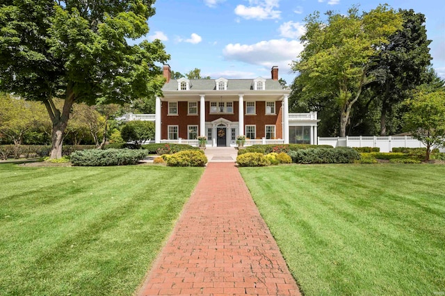 greek revival house with a front lawn