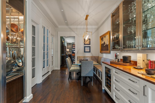 dining room with ornamental molding, dark hardwood / wood-style floors, and wine cooler