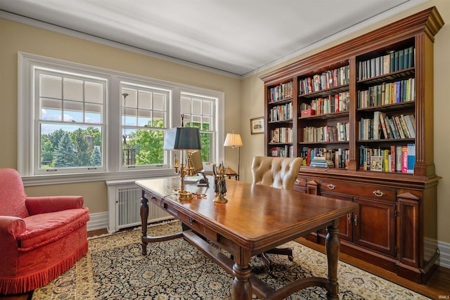 home office with radiator, hardwood / wood-style flooring, and crown molding