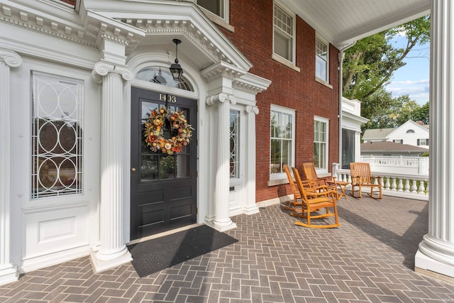 view of exterior entry featuring a porch