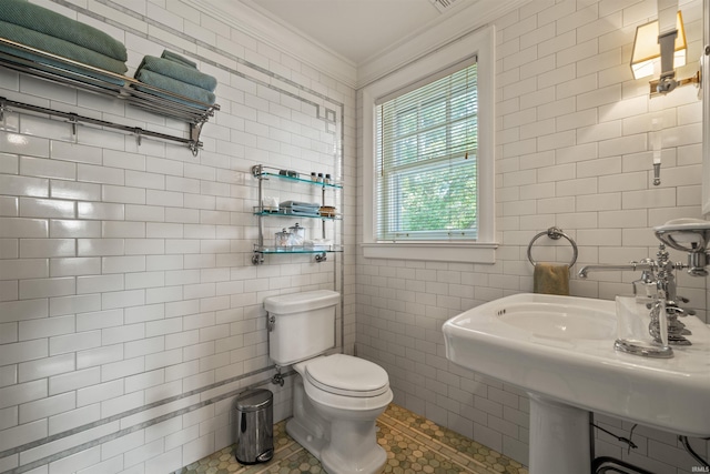 bathroom featuring tile walls, toilet, ornamental molding, and tile patterned floors