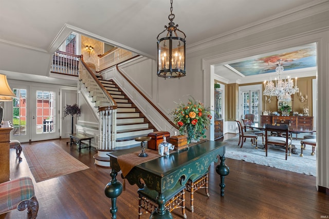 dining room featuring dark wood-type flooring, a chandelier, french doors, and crown molding