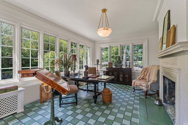 sunroom featuring a wealth of natural light and a premium fireplace