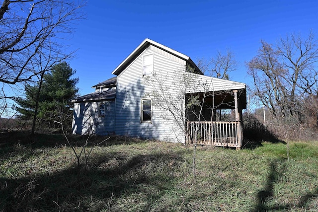 view of side of property featuring a porch