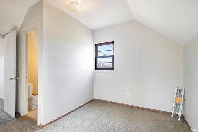 additional living space with carpet flooring and vaulted ceiling