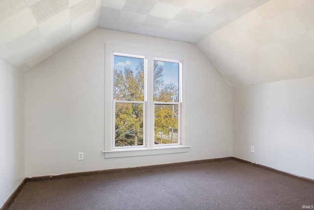 additional living space featuring carpet flooring, a healthy amount of sunlight, and lofted ceiling