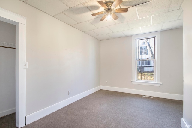 interior space featuring a drop ceiling and ceiling fan