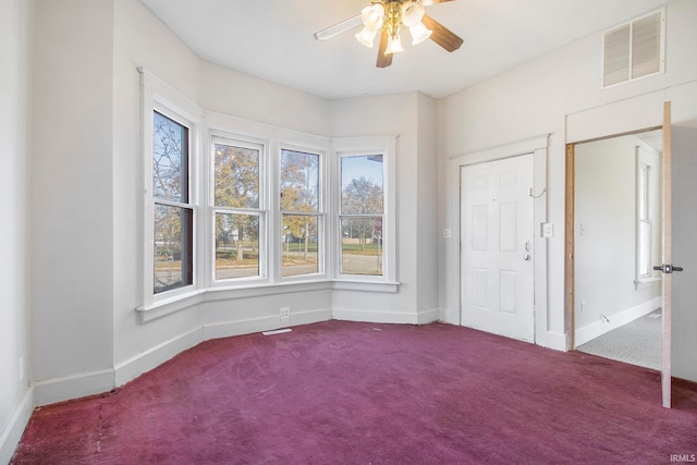 spare room with carpet and ceiling fan