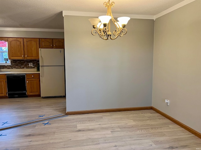 kitchen with dishwasher, decorative light fixtures, white fridge, and light hardwood / wood-style flooring