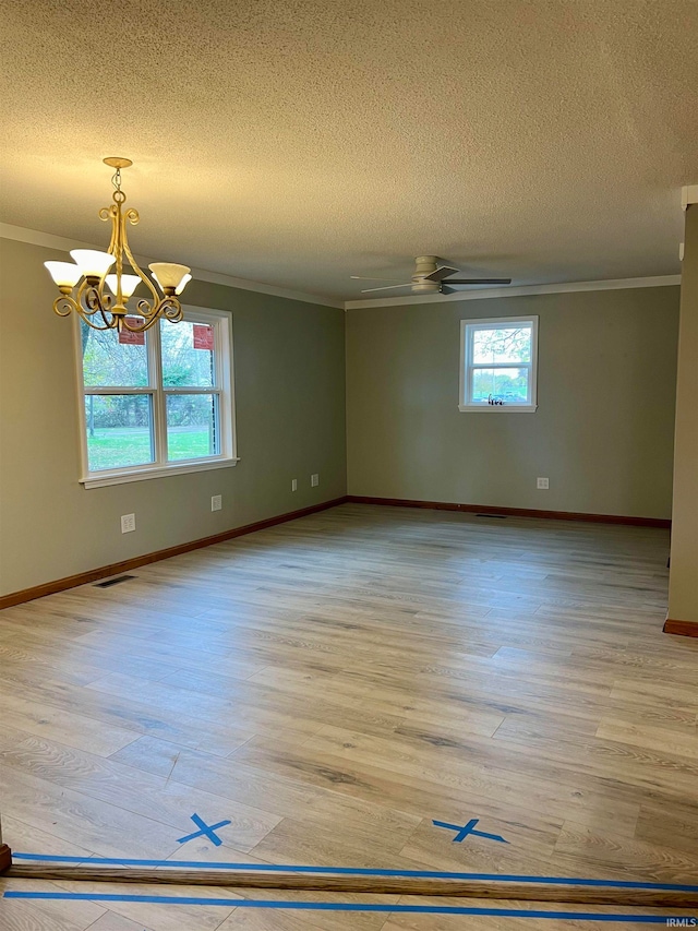 unfurnished room featuring plenty of natural light, light hardwood / wood-style floors, a textured ceiling, and ornamental molding