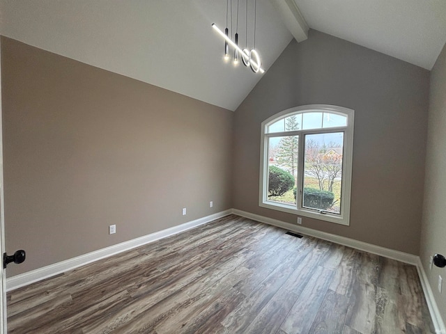 unfurnished room with vaulted ceiling with beams, hardwood / wood-style flooring, and an inviting chandelier