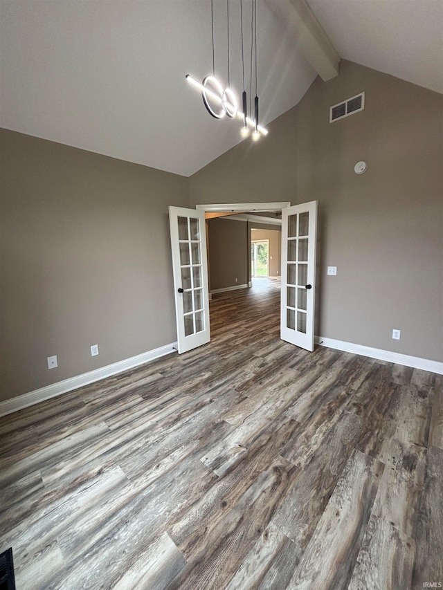 unfurnished dining area featuring hardwood / wood-style floors, french doors, and lofted ceiling with beams