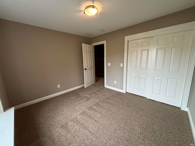 unfurnished bedroom with carpet floors and a closet