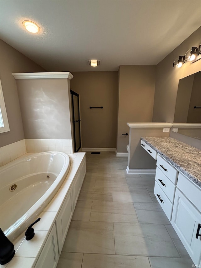 bathroom featuring vanity, a tub to relax in, and toilet