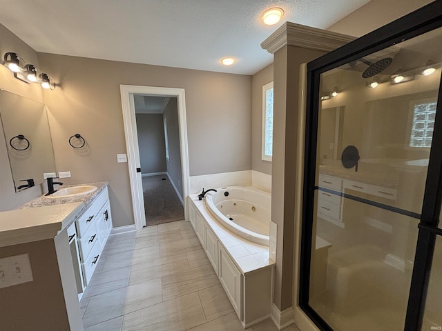 bathroom featuring independent shower and bath, vanity, a textured ceiling, and tile patterned floors