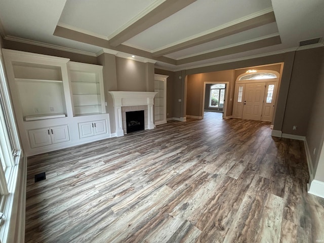 unfurnished living room with a tiled fireplace, hardwood / wood-style flooring, ornamental molding, and a raised ceiling