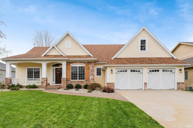 135 Ln 335 Lake James Ln, Angola, IN 46703 - craftsman-style house with stone siding, concrete driveway, a front yard, and roof with shingles