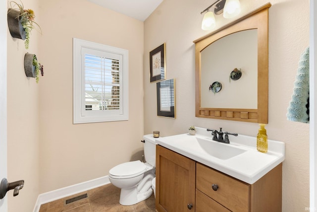 bathroom with tile patterned flooring, vanity, and toilet