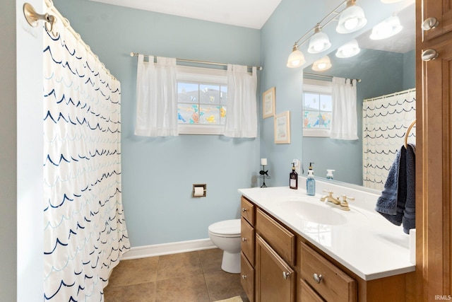 bathroom featuring vanity, toilet, walk in shower, and tile patterned flooring