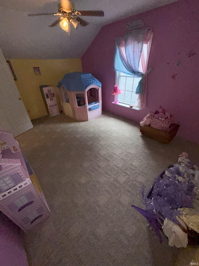 bedroom featuring ceiling fan, a textured ceiling, lofted ceiling, and carpet floors