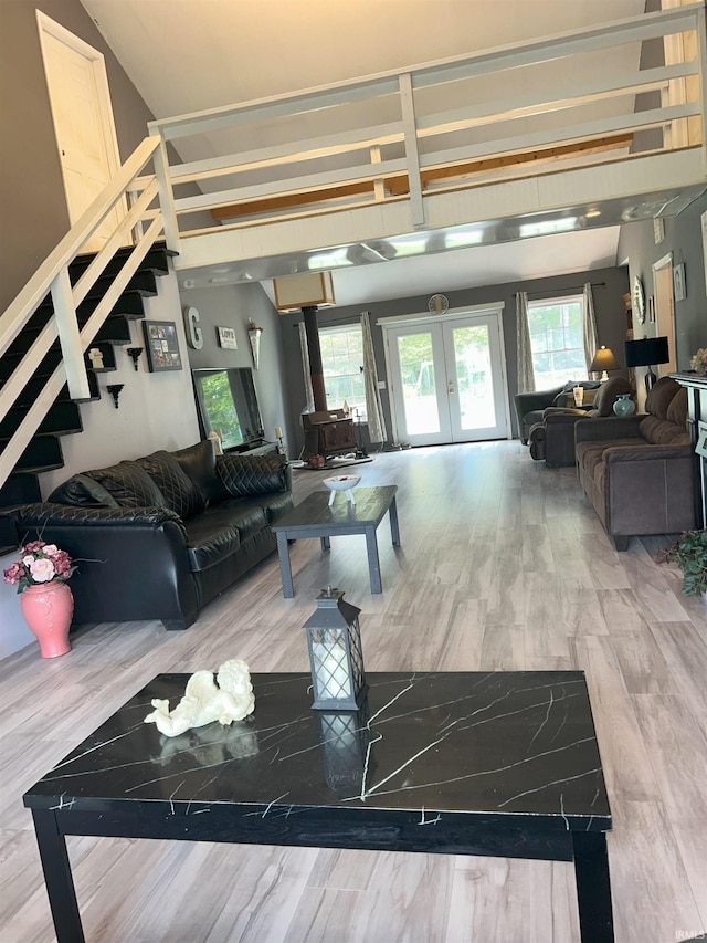 living room featuring french doors, a wealth of natural light, and hardwood / wood-style flooring