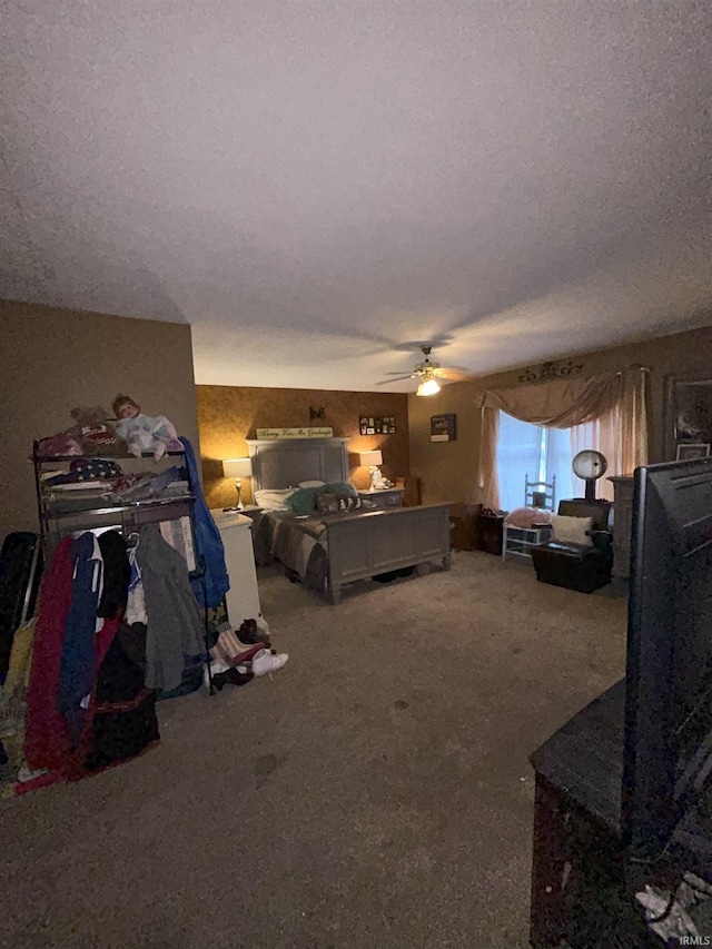 carpeted bedroom with a textured ceiling and ceiling fan