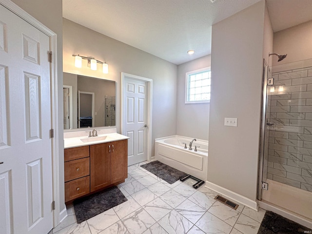 bathroom with vanity, plus walk in shower, and a textured ceiling