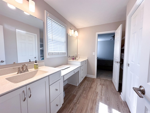 bathroom featuring vanity, hardwood / wood-style floors, and ceiling fan