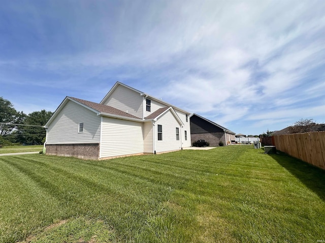 view of side of property with a lawn