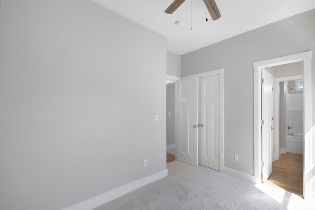 unfurnished bedroom featuring light carpet and ceiling fan