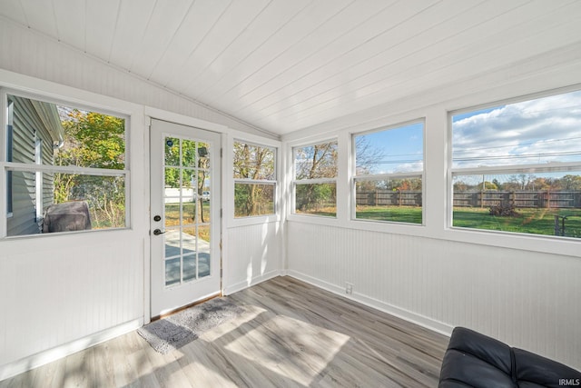 sunroom featuring lofted ceiling and wooden ceiling