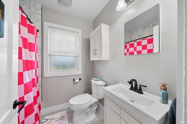 bathroom featuring walk in shower, tile patterned floors, vanity, and toilet