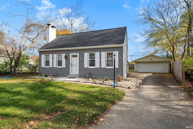 view of front of property featuring an outbuilding, a garage, and a front yard