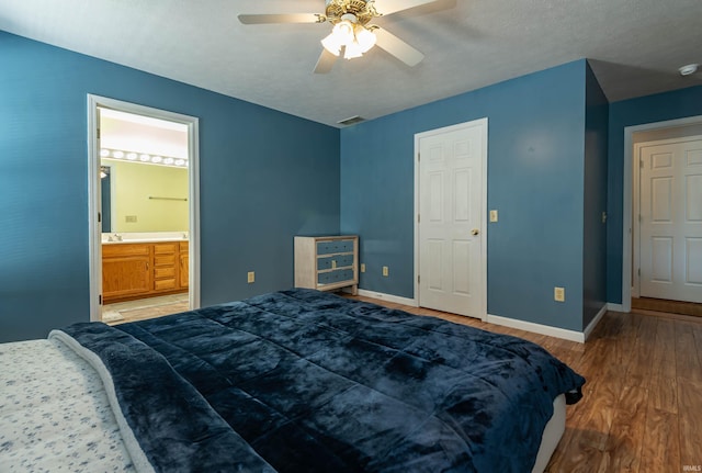 bedroom featuring ceiling fan, wood-type flooring, connected bathroom, and a textured ceiling