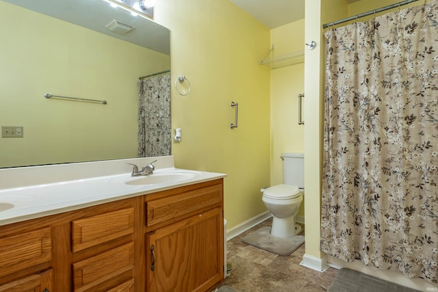 bathroom featuring toilet, vanity, and a shower with shower curtain