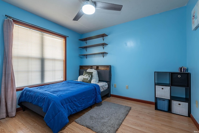 bedroom with light hardwood / wood-style floors and ceiling fan