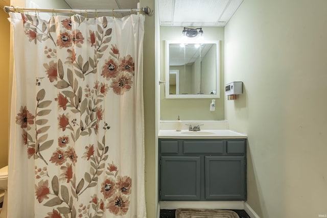 bathroom with toilet, vanity, and a shower with shower curtain