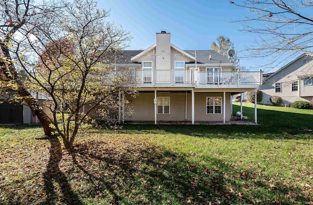 rear view of property with a lawn and a deck