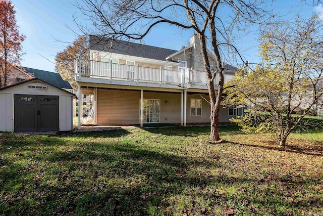 back of house with a lawn, a shed, and a wooden deck