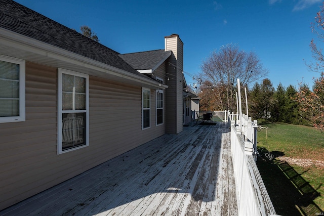 wooden terrace with a lawn