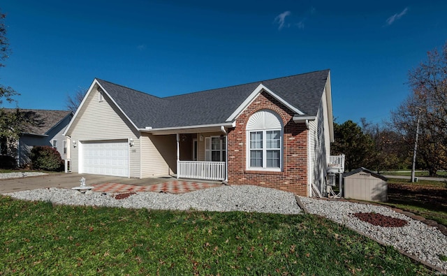 view of front of home featuring a porch, a front yard, and a garage