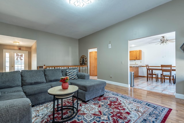 living room with ceiling fan and light hardwood / wood-style flooring