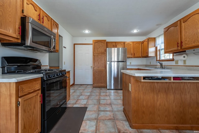 kitchen featuring sink, light tile patterned floors, and stainless steel appliances