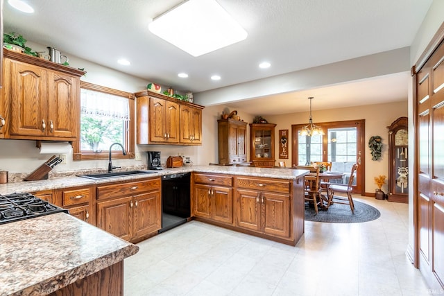 kitchen with decorative light fixtures, black dishwasher, sink, an inviting chandelier, and kitchen peninsula