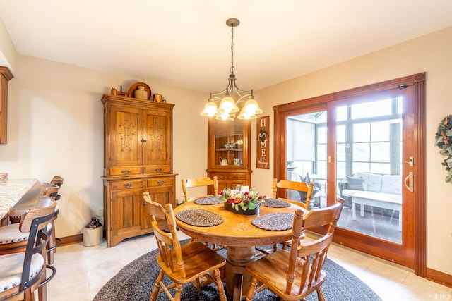 dining area with light tile patterned flooring and a notable chandelier