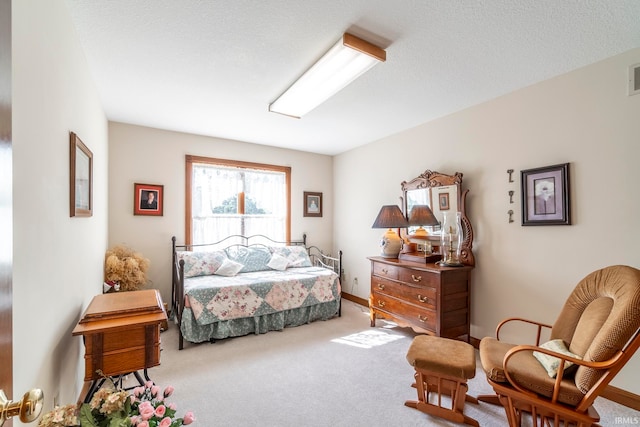 carpeted bedroom featuring a textured ceiling