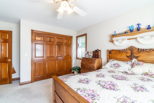 bedroom with ceiling fan, a closet, and light colored carpet