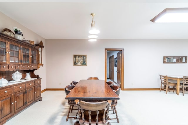 dining area featuring light colored carpet