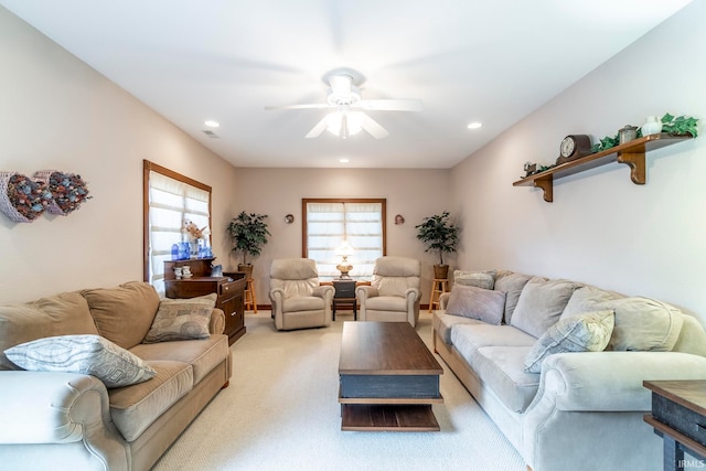 living room with ceiling fan and light colored carpet